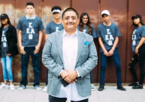 A group of people standing in front of a wall for Tough Talks with Youth by Carlos Nicasio (San Diego 2008).