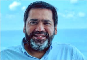 A bearded man, Gilbert Hernandez, became a youth pastor at 18, empowering youth through discipleship in San Antonio with DVULI.
