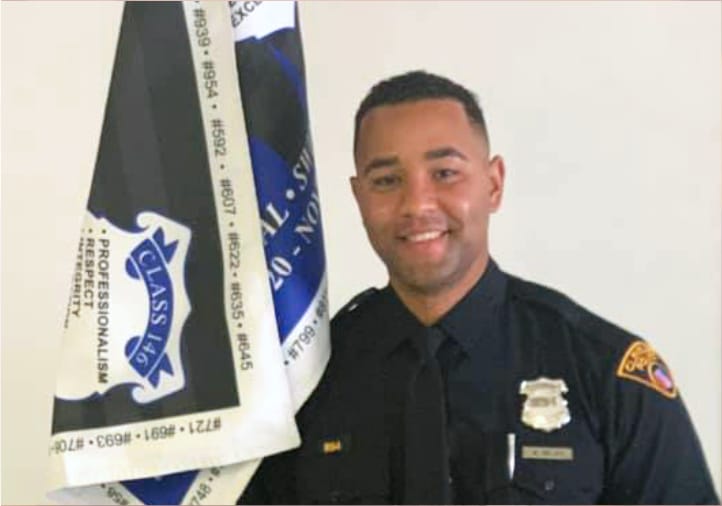 A Cleveland police officer holding a flag: Wesley Reyes graduates from the police academy, fulfilling God's call.