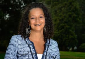 Nike Greene, a woman with curly hair from Portland 2005, shares her calling to serve youth through community-led violence prevention initiatives.