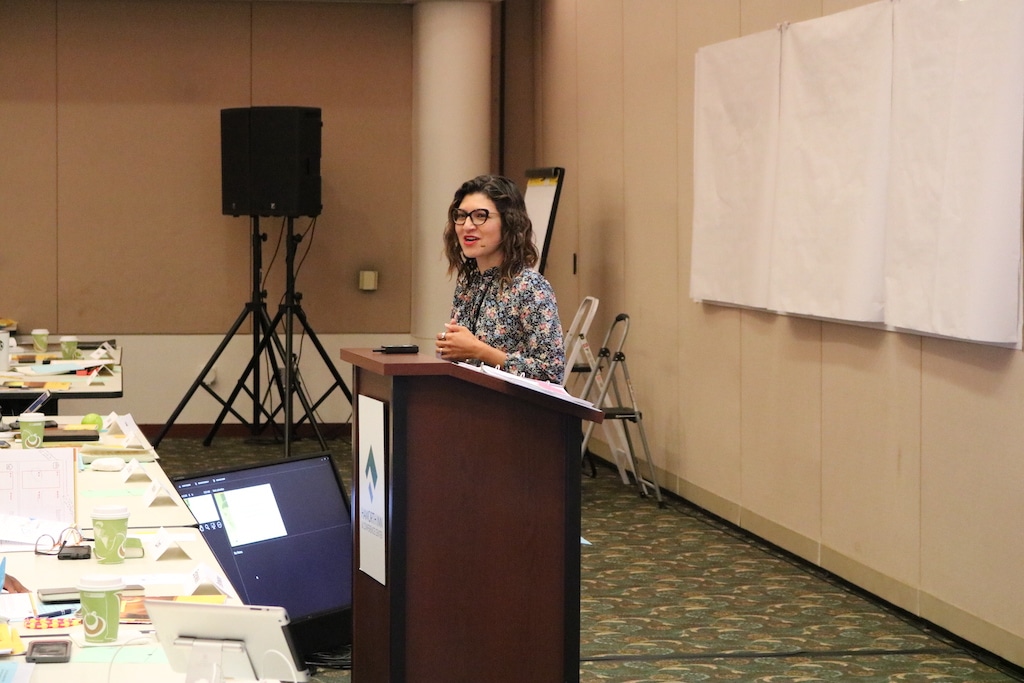 A woman giving a DVULI presentation, providing urban youth leader training and resources for underserved communities.