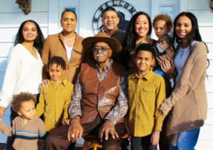 A joyful scene of a Hispanic family posing for a photo to celebrate their culture and family.