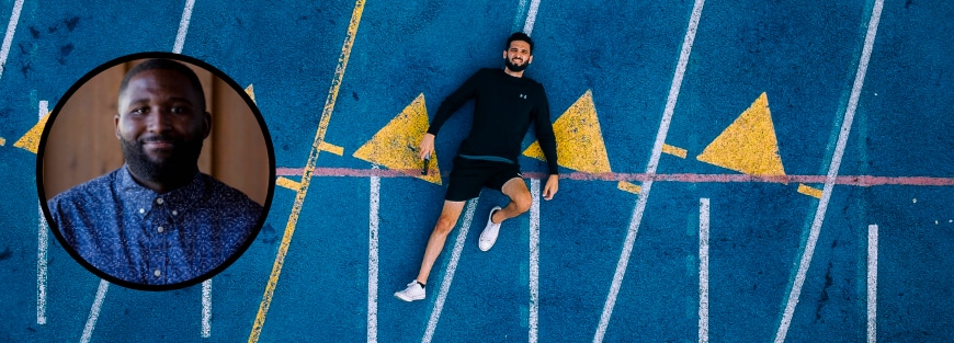 Man laying on a track emphasizes the need to slow down in urban youth work. Tips by Jordan Francis.